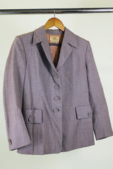 Women's vintage 1950's Jack Frost Woolen Wear, The Original Utah Woolen Mills, Salt Lake City label long sleeve grey colored button up blazer with double lapel, two pockets, and fabric covered buttons.