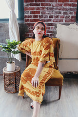 Women's vintage 1970's Fashion Manor, Decorator Collection label short sleeve ankle length dress in a mustard yellow and brown floral print cotton towel material.