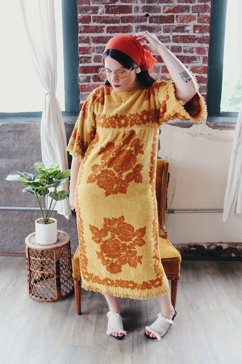 Women's vintage 1970's Fashion Manor, Decorator Collection label short sleeve ankle length dress in a mustard yellow and brown floral print cotton towel material.