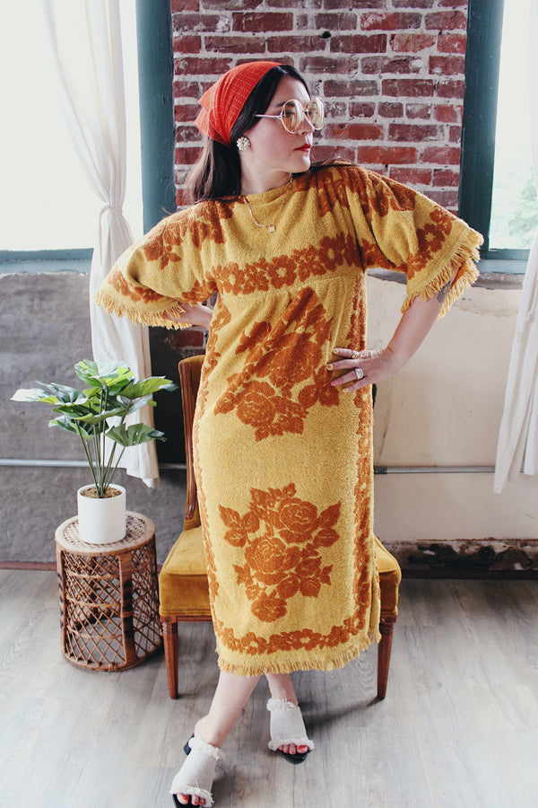 Women's vintage 1970's Fashion Manor, Decorator Collection label short sleeve ankle length dress in a mustard yellow and brown floral print cotton towel material.