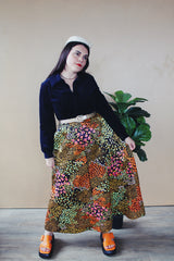 Women's vintage 1960's Lounging Apparel Evelyn Pearson label long sleeve maxi length twofer house dress with a black velvet top part and multicolored floral print skirt. 