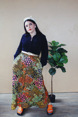Women's vintage 1960's Lounging Apparel Evelyn Pearson label long sleeve maxi length twofer house dress with a black velvet top part and multicolored floral print skirt. 