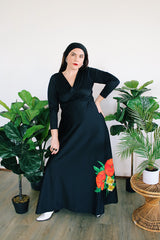 Women's vintage 1970's long sleeve maxi length black polyester material dress with big red and green flower graphic on the side