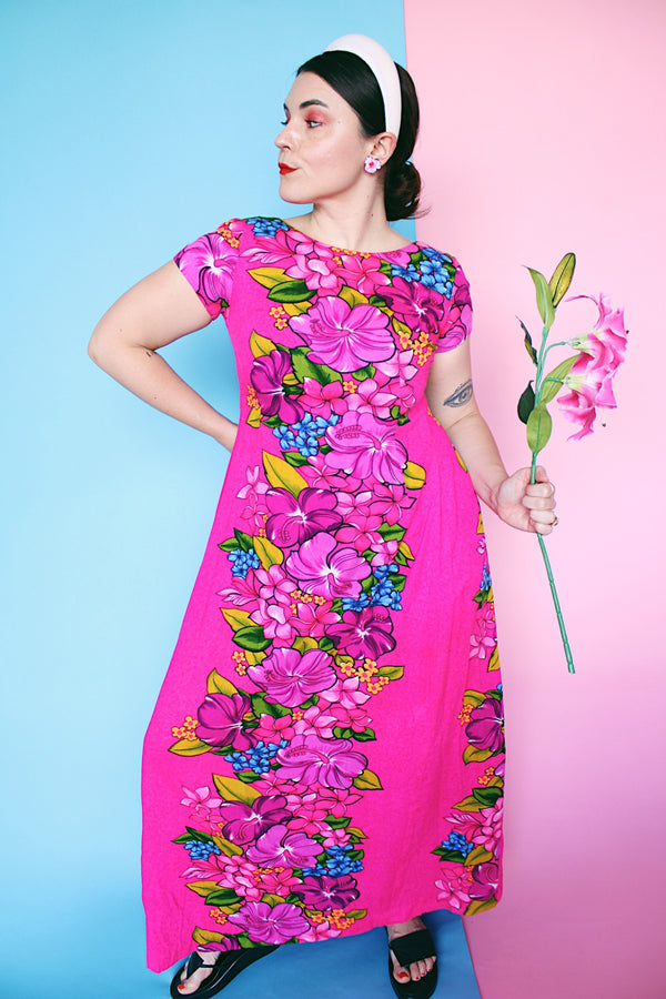 Women's vintage 1960's Skirts & Blouses Specialty Shop Honolulu label short sleeve ankle length bright pink cotton material dress with all over Hawaiian floral print.