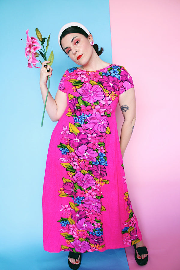 Women's vintage 1960's Skirts & Blouses Specialty Shop Honolulu label short sleeve ankle length bright pink cotton material dress with all over Hawaiian floral print.