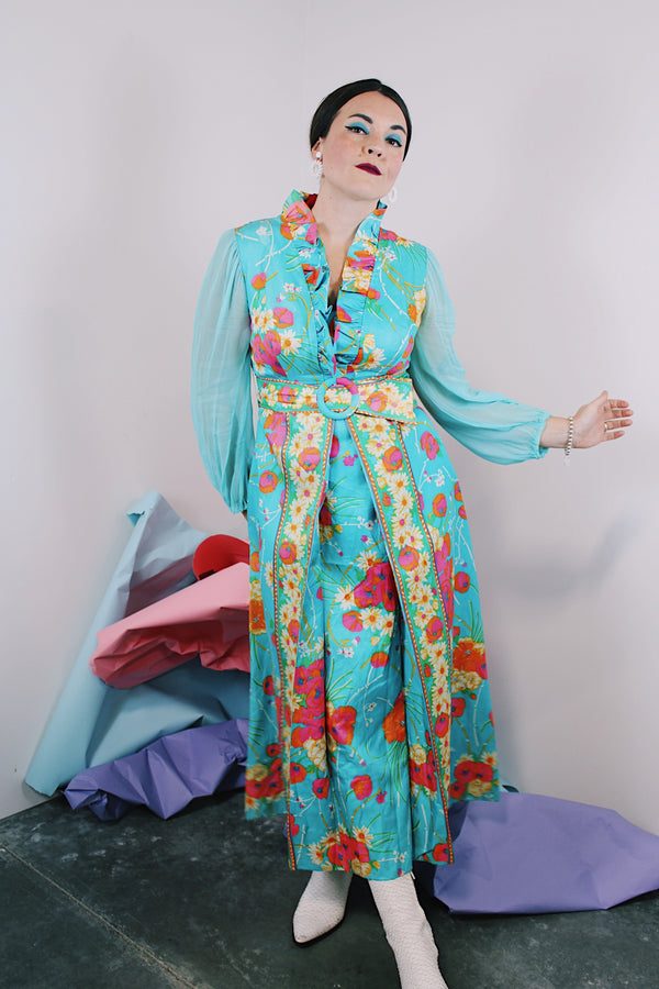 Women's vintage 1970's long sleeve ankle length dress in blue with all over orange and pink floral print.
