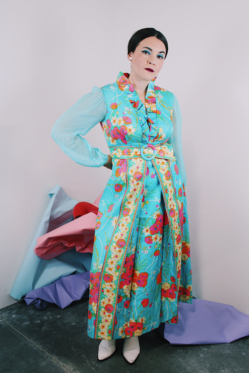 Women's vintage 1970's long sleeve ankle length dress in blue with all over orange and pink floral print.