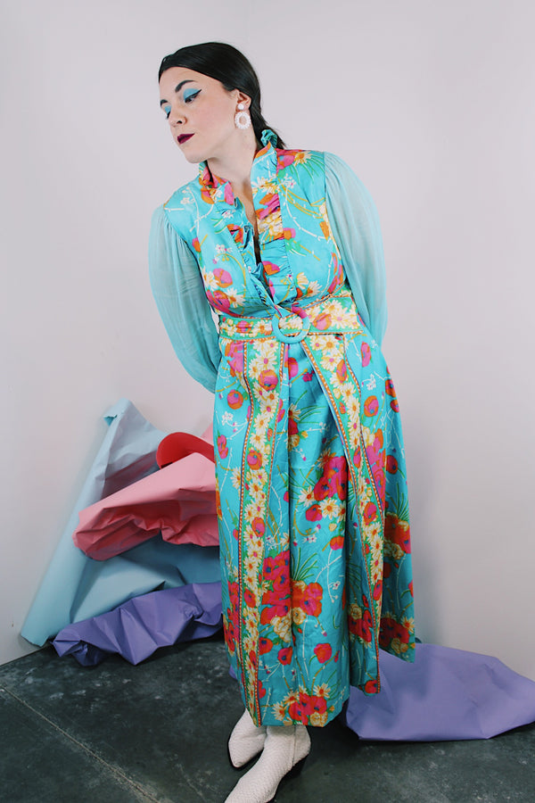 Women's vintage 1970's long sleeve ankle length dress in blue with all over orange and pink floral print.