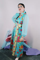 Women's vintage 1970's long sleeve ankle length dress in blue with all over orange and pink floral print.