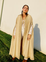 beige wool poncho ape with beaded and gold ribbon trim and pointy collar vintage women's 1960's