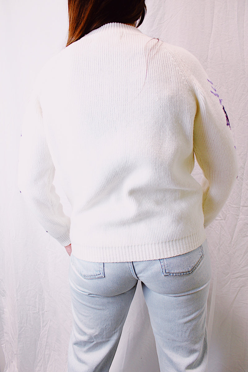 long sleeve white turtleneck vintage 1980's ski sweater in white with purple snowflake print