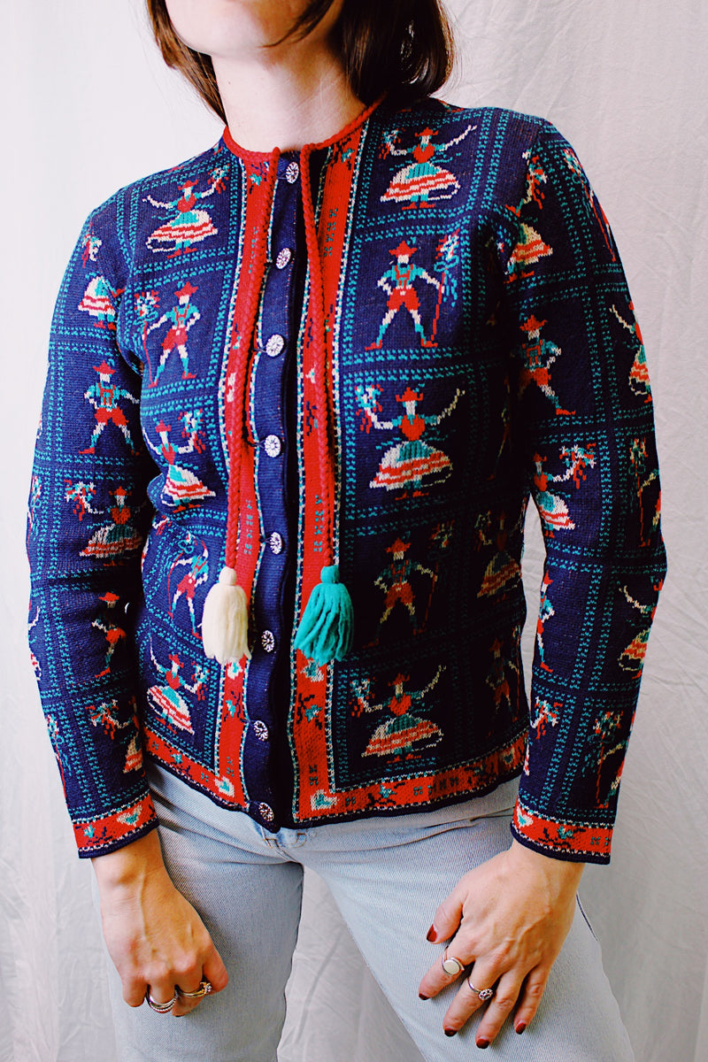 vintage 1960's long sleeve cardigan sweater with tassel drawstring caricature print all over navy with red and green print