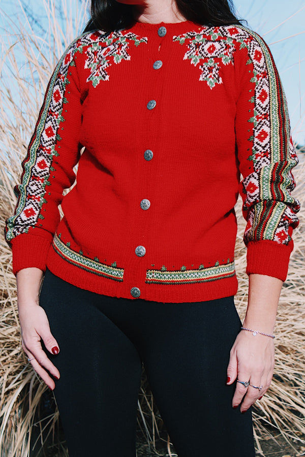 long sleeve wool red norwegian sweater with white and green print with silver buttons up the front