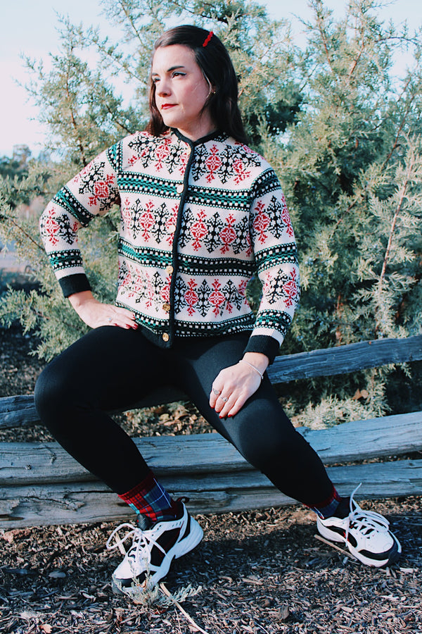 long sleeve wool sweater cream with red, green, and black print gold buttons up the front 