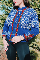 long sleeve wool blue norwegian sweater with white print and red trim and silver metal claps buttons