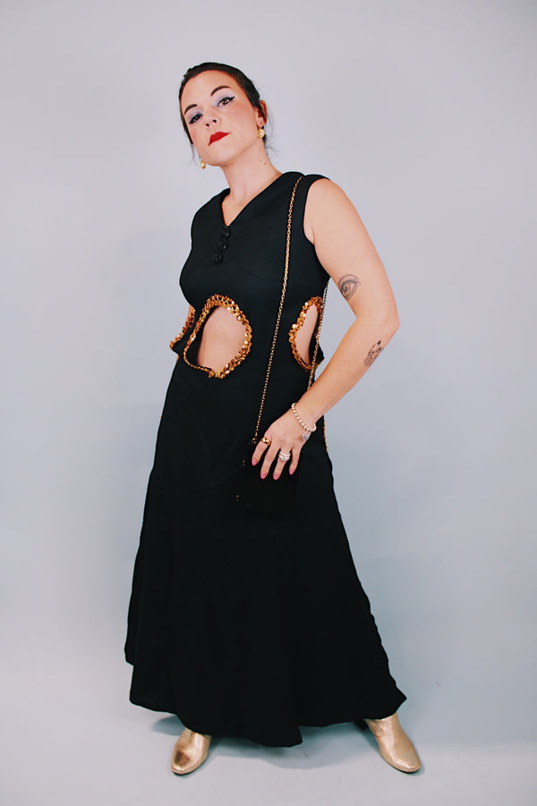 vintage 1970's ankle length black sleeveless dress with waist cut outs that have gold sequined trim