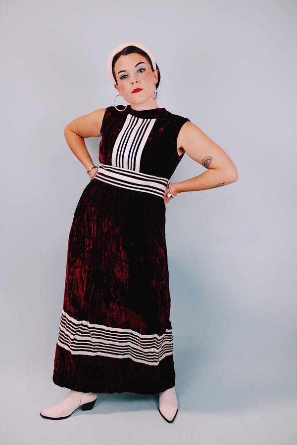 sleeveless floor length maroon velvet dress with mock neck and white striped details