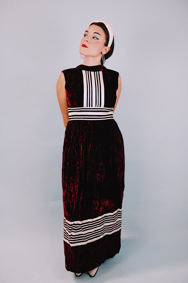 sleeveless floor length maroon velvet dress with mock neck and white striped details