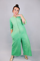 3/4 arm length green velour pajama jumpsuit with gold trim and zipper in front