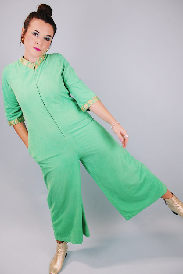 3/4 arm length green velour pajama jumpsuit with gold trim and zipper in front