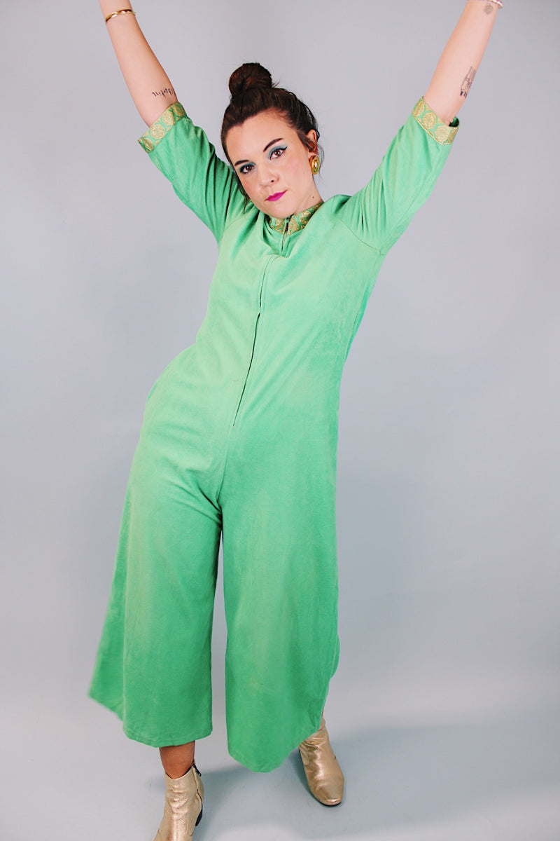 3/4 arm length green velour pajama jumpsuit with gold trim and zipper in front