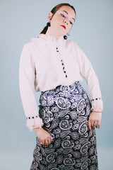 long sleeve white blouse with buttons in the back and chiffon ruffle details around cuffs and neck vintage 
