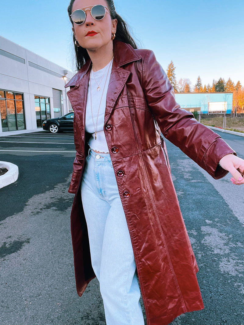 long maroon faux leather trench coat with buttons double lapel and tie waist vintage 1970's
