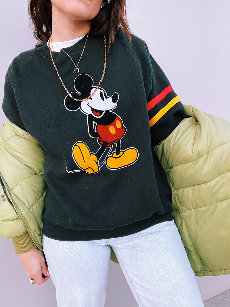 long sleeve pullover sweater in black with felt mickey mouse graphic on front