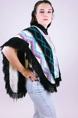 1980's vintage women's acrylic knit poncho with black fringe hem