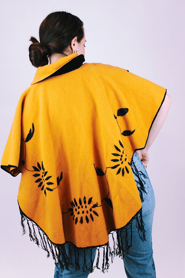 mustard yellow women's vintage wool poncho with black fringe and small collar and embroidered flowers