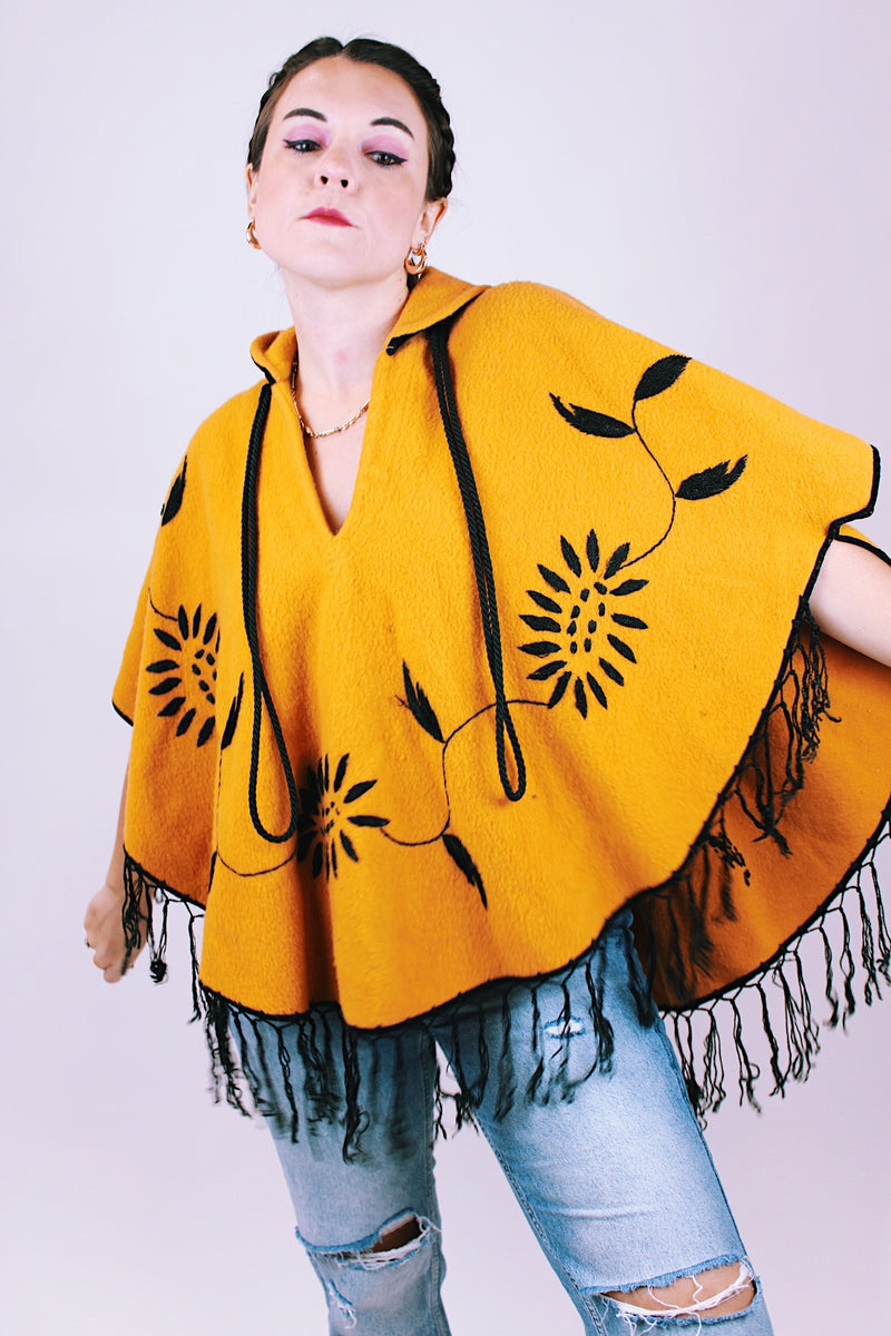 mustard yellow women's vintage wool poncho with black fringe and small collar and embroidered flowers