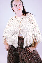 women's vintage short poncho with fringed hem and button closure in cream color
