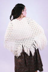 women's vintage short poncho with fringed hem and button closure in cream color