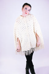 women's 1970's vintage cream acrylic knitted crochet poncho with fringed hem, collar, and buttons