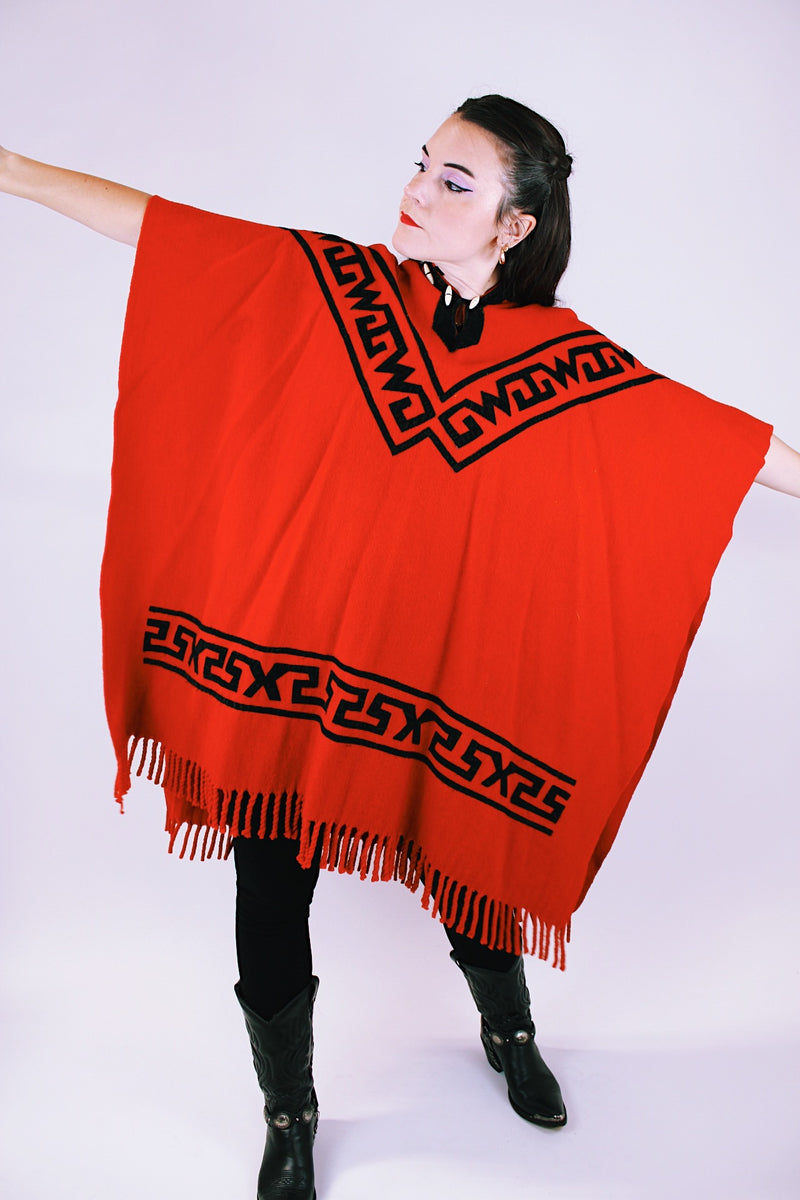 1970's vintage red wool poncho with abstract velvet trim pattern and fringe hem