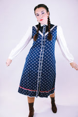 1970's vintage gunne sax prairie dress with navy floral body and white sheer sleeves buttons up the front