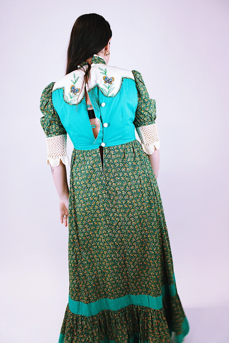 1970's vintage prairie dress in green ditsy floral print, crochet sleeves mock neck embroidered butterflies on chest 
