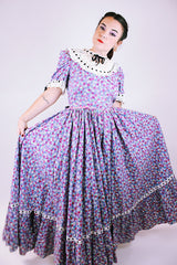 purple floral 1950's prairie dress with large full skirt and black ribbon bows 
