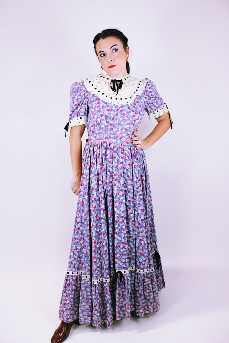 purple floral 1950's prairie dress with large full skirt and black ribbon bows 