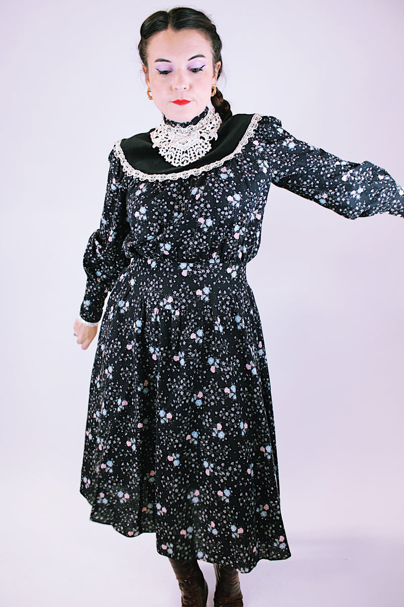 vintage 1970's gunne sax dress with long sleeves in black with ditsy floral print has lace trim and mock neck 