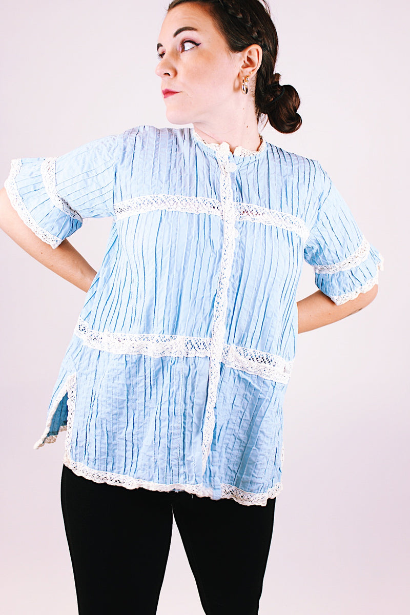 short sleeve baby blue 1970's women's vintage button up blouse with crochet lace throughout