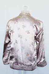 Women's vintage 1950's long sleeve reversible satin open jacket in bright purple and light lavender. Side slits, front pockets and small shoulder pads