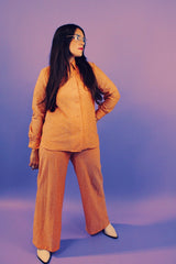 peach metallic set with long sleeve button up collared blouse and elastic waistband pants with slight flair